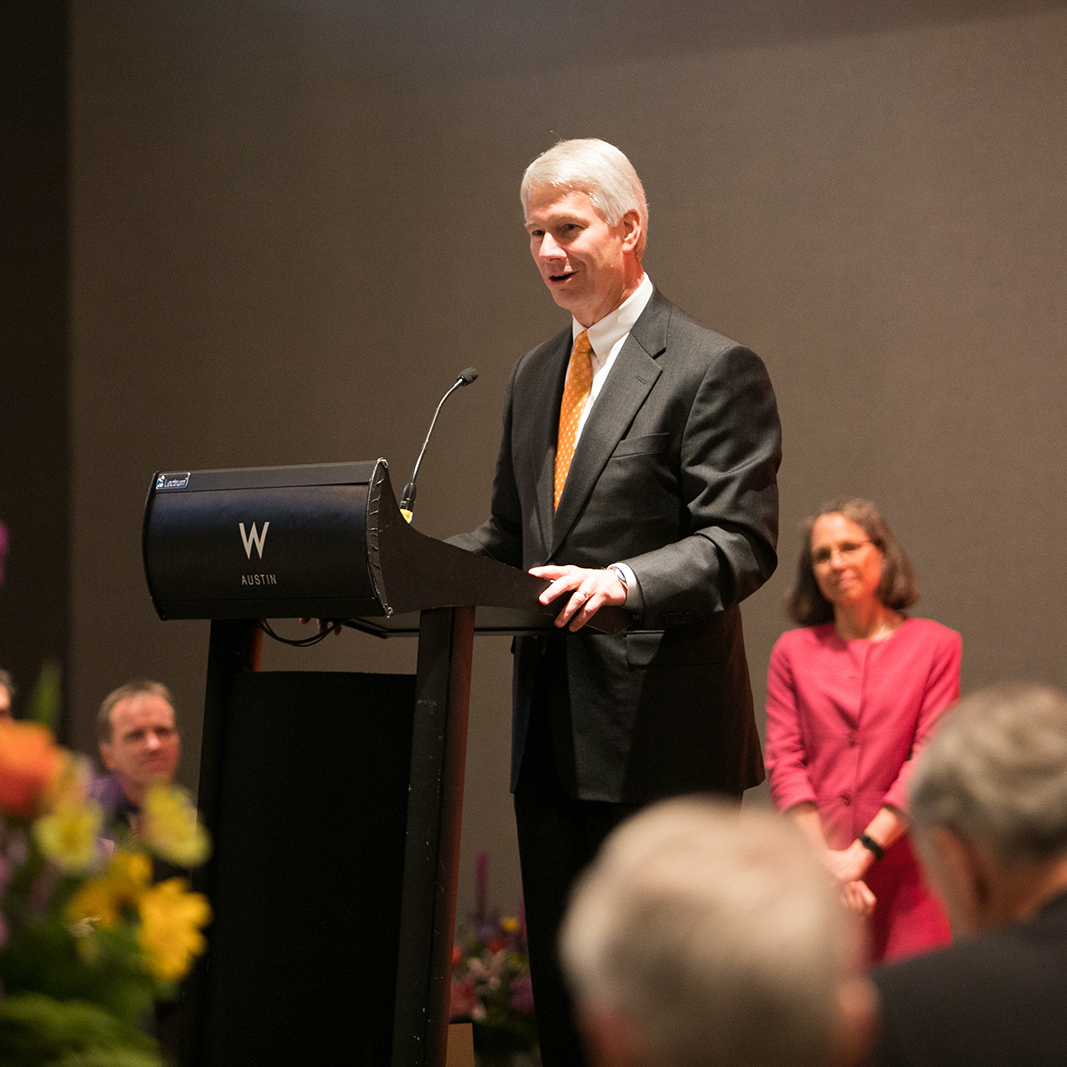 Sam Dawson stands at a podium to give a speech