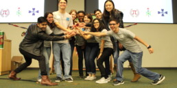 Group of students smile and and hold trophy at event