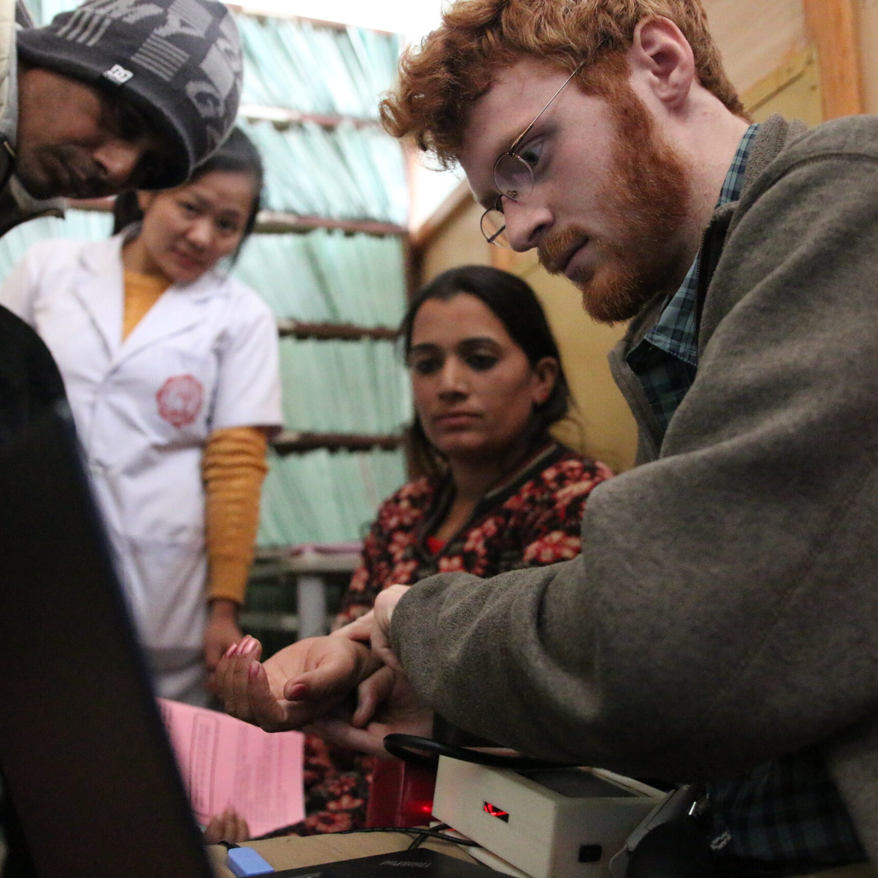 Student checks pulse of woman